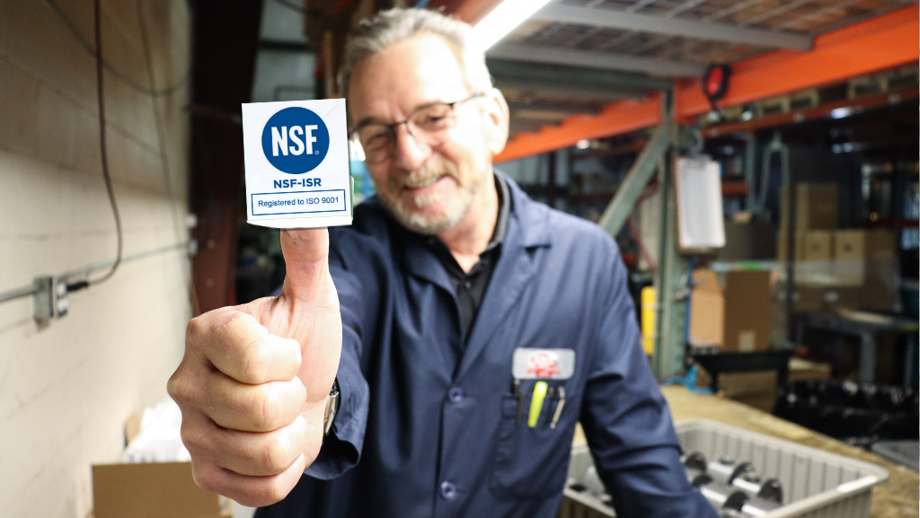 ISO 9001 certification with Steve holding a sticker on his thumb.